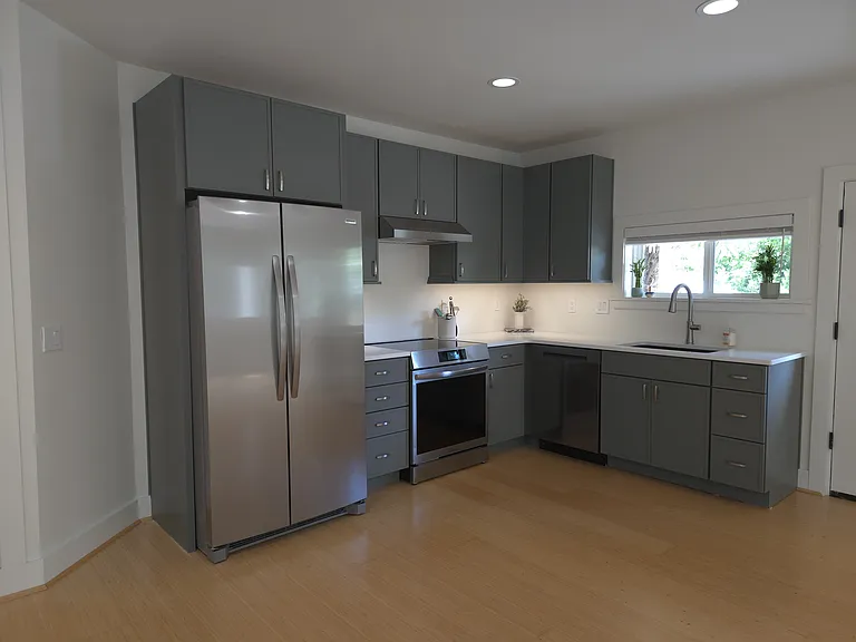 Everything is brand new. Backsplash is going in this week. Induction range, full size fridge, dishwasher, disposal, under cabinet lighting. Microwave and movable kitchen island available.