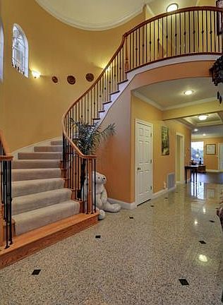 A sweeping stairway leads to the second floor.