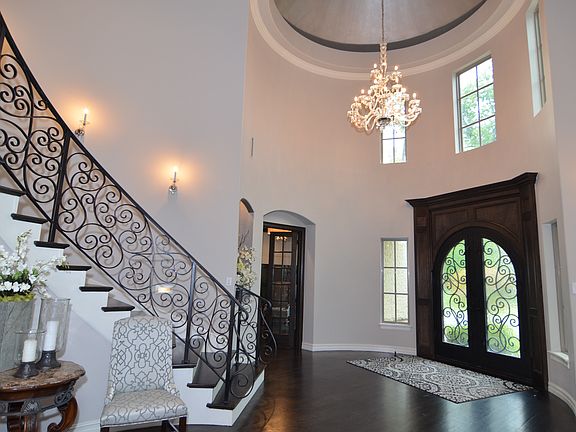 One of a kind foyer. Rob Key designed the 8 foot double iron door w/ rain glass to complement stairs