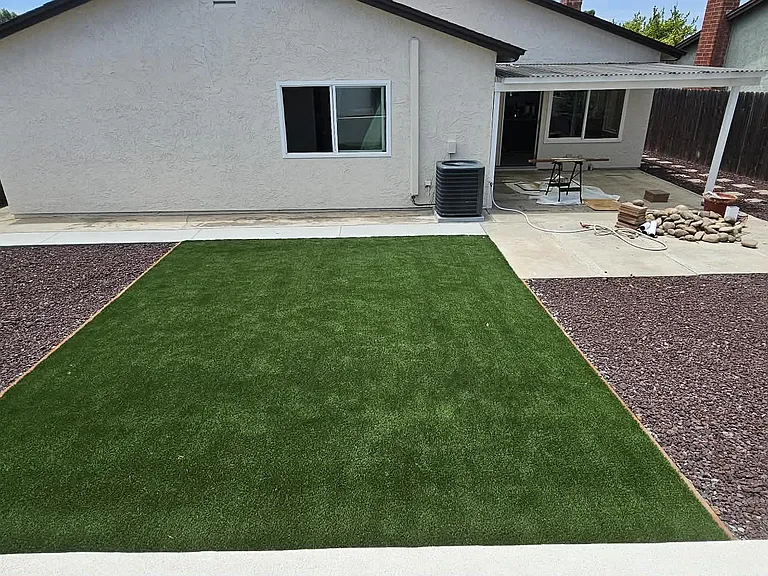 Backyard - Covered patio, gravel and turf.