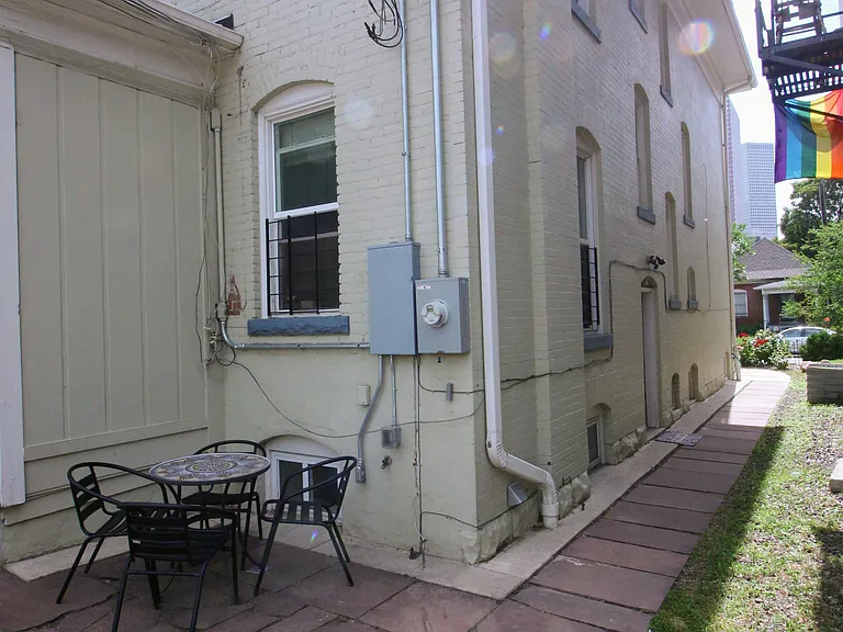 Shared back patio with hanging lights for relaxing, grilling, or entertaining