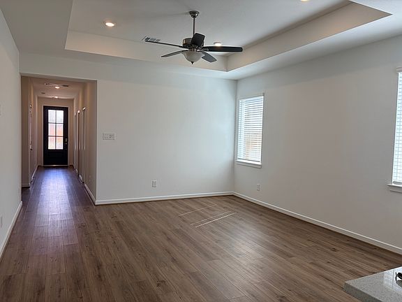 An inviting entry opens to gorgeous vinyl flooring that joins the living area.