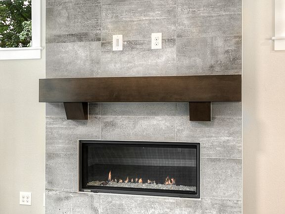 Contemporary fireplace with full-height tile surround