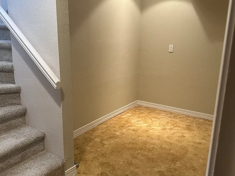 Storage area at the bottom of the stairs