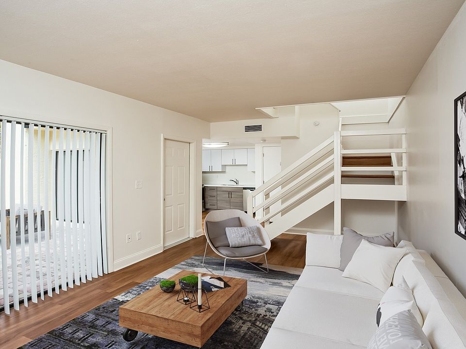 Spacious living room with access to private patio and wood flooring throughout