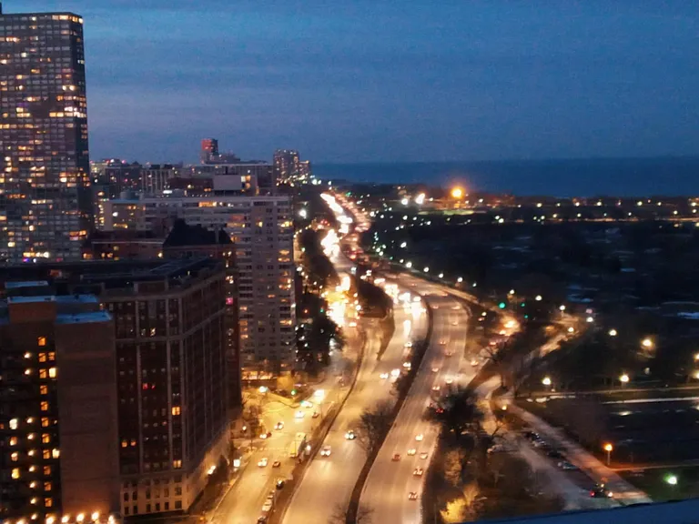 North view of iconic Lakeshore Drive and Montrose Harbor from the rooftop at dusk