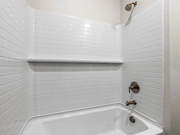 The secondary bathroom has a shower-tub combo.