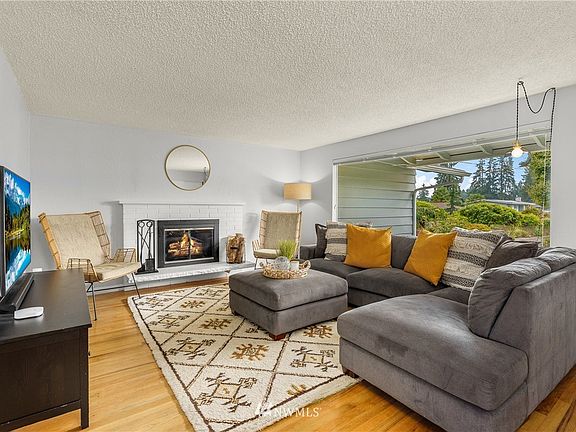 Wonderful living room with wood-burning fireplace and hearth; vintage of the decade.
