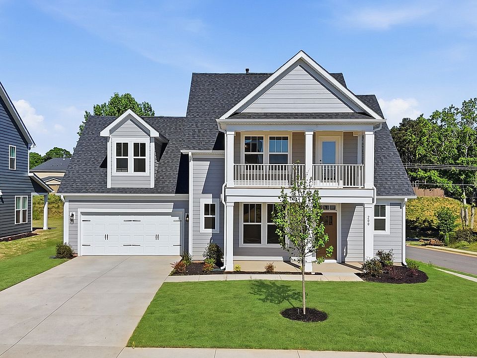White exterior Sutherland new two story home with stone columns, blue door two car garage at Wells