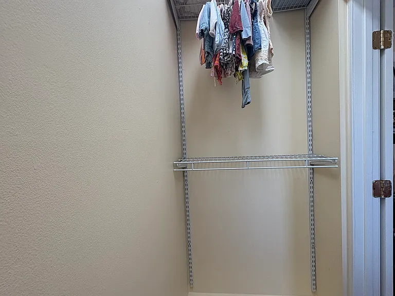 Second bedroom walk in closet with adjustable shelving system