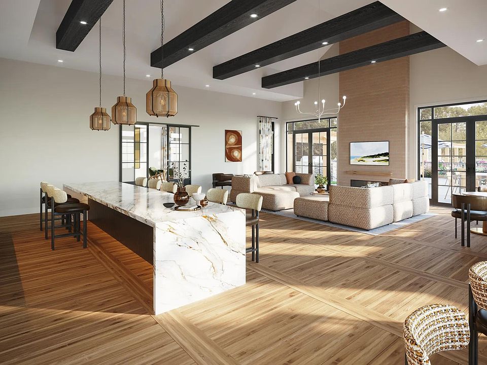 Expansive clubroom with gathering space, catering kitchen, indoor/outdoor fireplace, and lounge seating near Boston, MA.