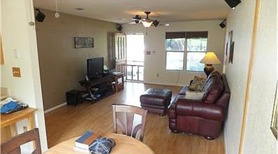 View from dining area.  Laminate wood flooring throughout. Note