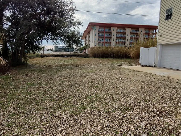 Rear drive, entrance to garage and recreational area for community.