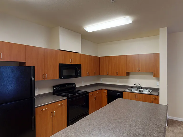 Apartment kitchen with tile flooring.