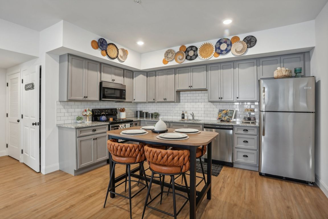 Designer Custom Kitchens with Granite Counters, Subway Tile and Stainless Steel Appliances