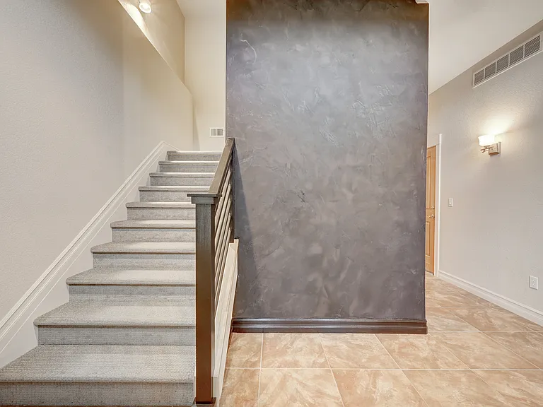 Stairs and elevator at front doorway