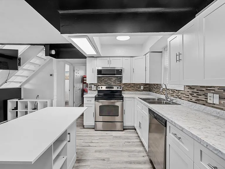 Open kitchen with brand new stainless steel appliances
