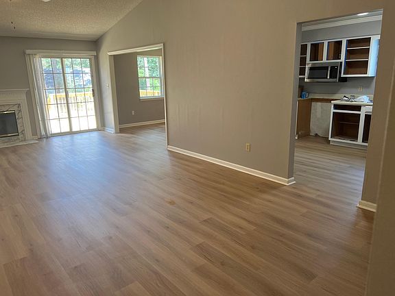 Living room view of kitchen and dining room