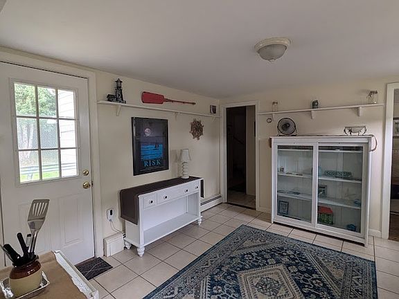 entry, leads to bedrooms upstairs to the left