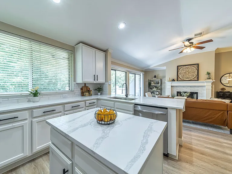 View of window in the kitchen that shows the green space behind the condo