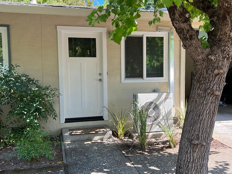 Front door. To the right is the covered, off-street parking spot and locking storage closet.