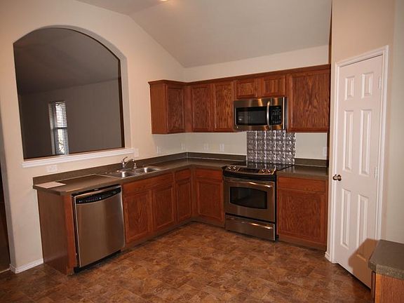 Open kitchen with stainless still appliances