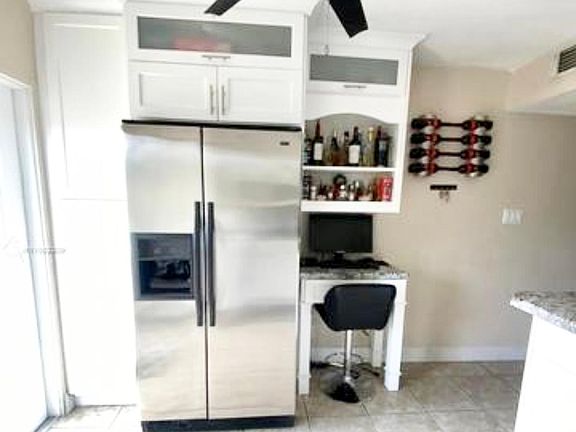 Updated, contemporary kitchen, with appliances, bright white wood cabinets, built-in microwave, and oven.