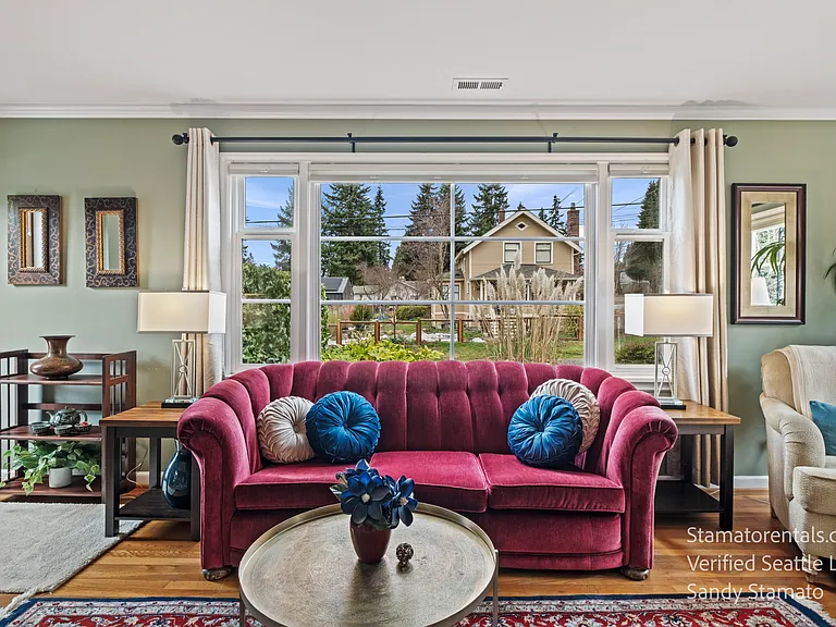 Bright, airy living room with original 1946 hardwood floors and new window treatments.
