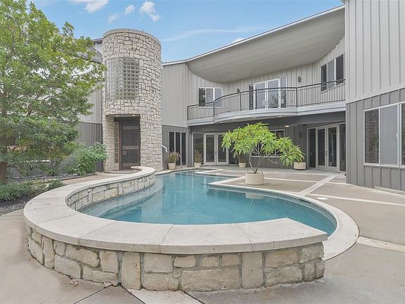 Another view of the large swimming pool & spa and backyard oasis. Multiple windows enhance the natural light throughout the home.