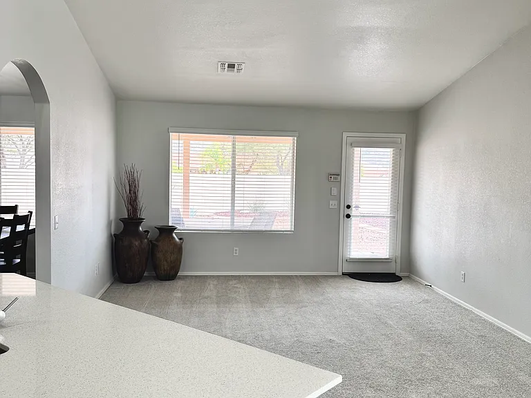 Open bonus room viewed from kitchen with door to outside covered patio and great views of the Catalina Mountains.