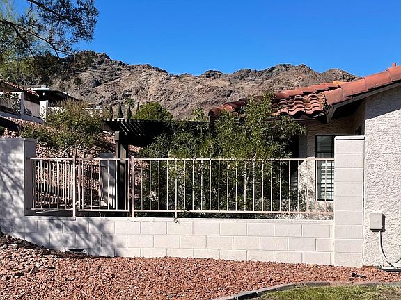 Street view looking at back of house and backyard thru fence