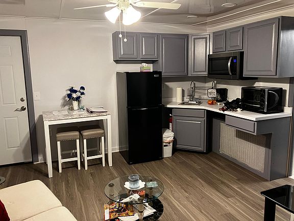 Efficiency Kitchen equipped with a tabletop powerful convection oven, Large, brand new microwave, coffee maker and an induction hot plate that can cook anything in mins. Pots and pans, dishes, glasses cutlery, refrigerator and high-top table with two chai