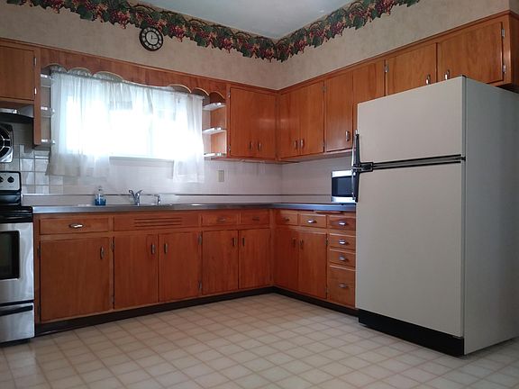 Solid wood cabinets; built-in cutting board and bread box