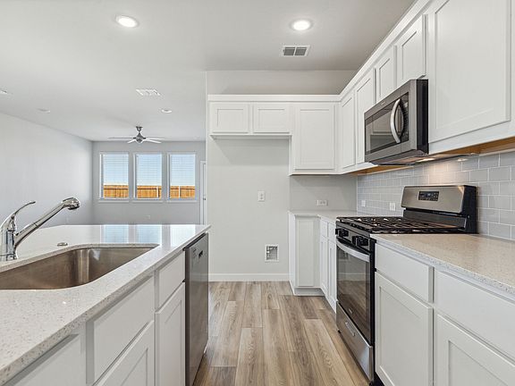 Kitchen in the Willow home plan by Trophy Signature Homes - REPRESENTATIVE PHOTO