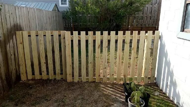 View of fence enclosure on left side with gate access
