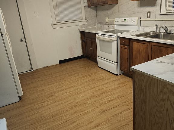 This is another view of the kitchen. The door on the far left, leads to the porch or pantry whichever you choose to make it. Dishwasher not included.