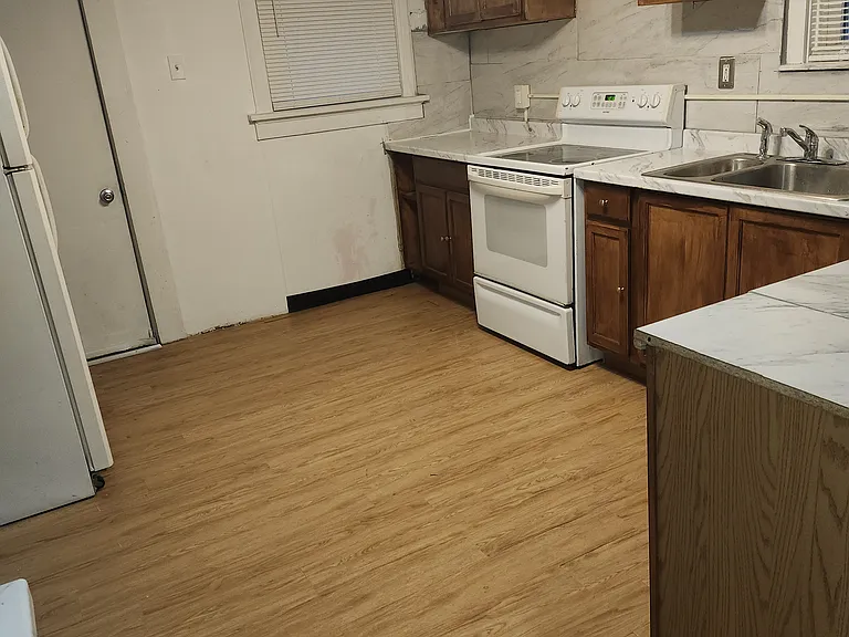 This is another view of the kitchen. The door on the far left, leads to the porch or pantry whichever you choose to make it. Dishwasher not included.