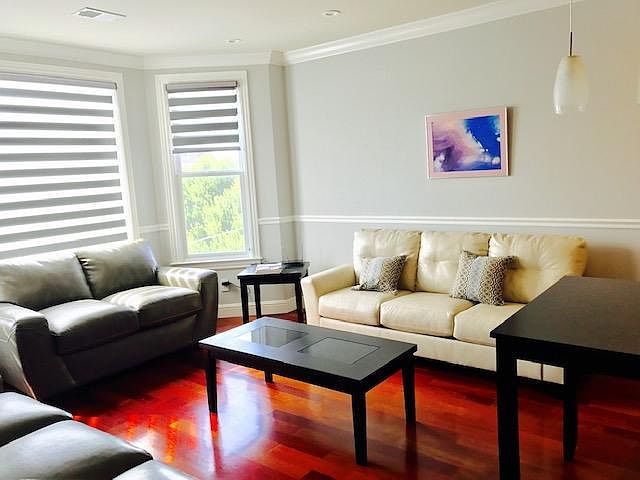 Living room can come furnished or unfurnished. There are currently two full-size couches and one love seat, two end tables and one coffee table, as seen here.