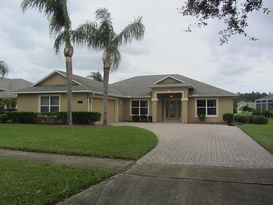 Extended brick paver driveway with side entry garage doors