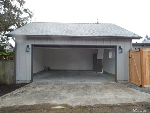 Fully finished detached 2 car garage with alley access and drop down ladder with tons of storage  above.