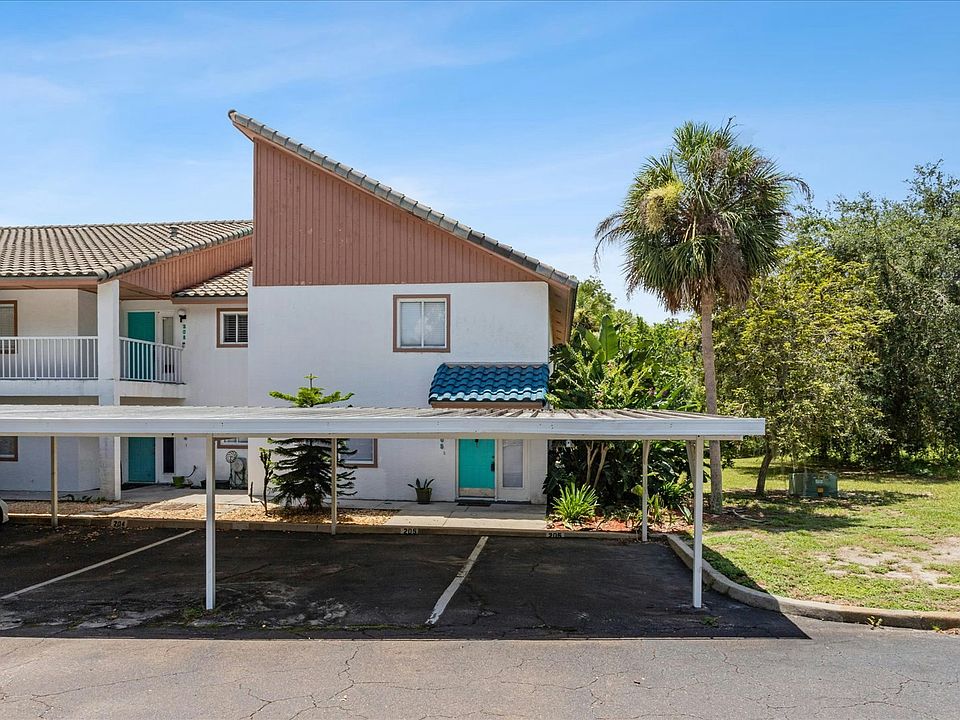 Condo building with 2 parking spots in front