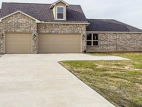 Massive three car garage with 8 foot tall doors, extra width and the single bay is big enough for a nice size boat or huge Texas truck!