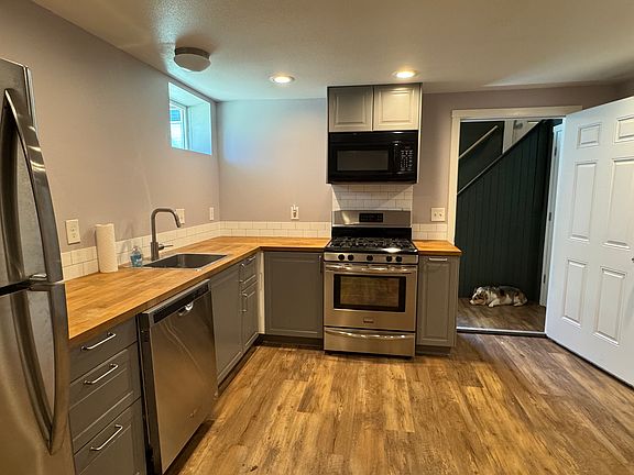 Full kitchen with new appliances. Dishwasher, gas stove, fridge, and built in microwave.