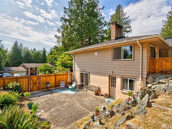Looking down to lower level of backyard with patio space off of the lower level and separate entrance to MIL area.