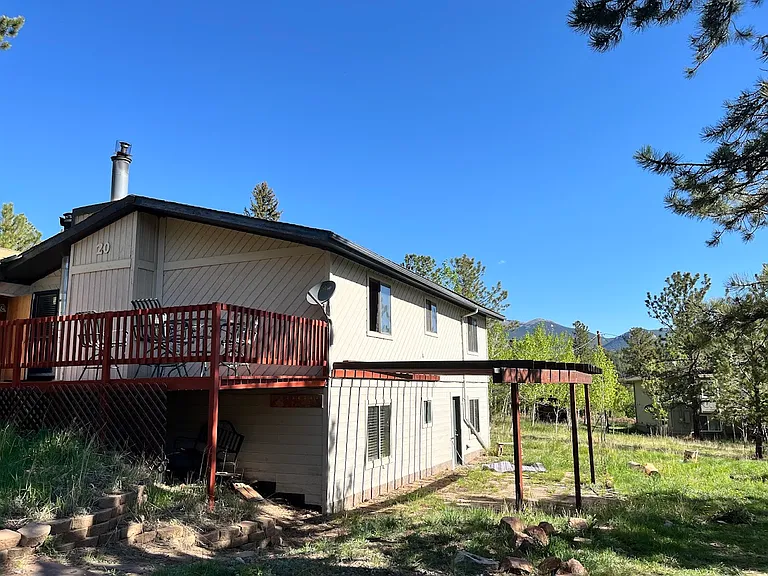 Side of house with flagstone patio.