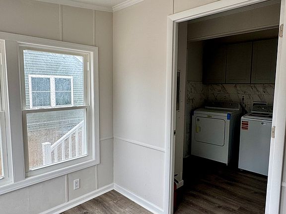 Entryway to the laundry room with additional cabinets for storage or pantry use.