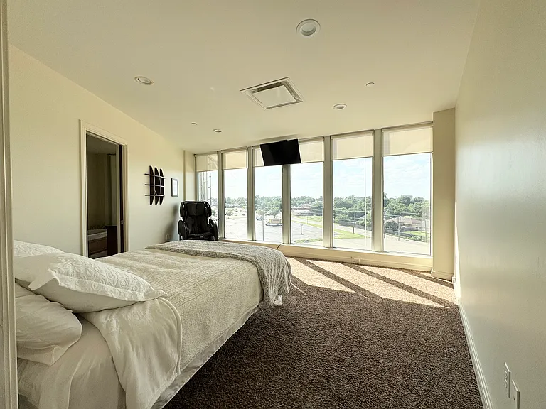 Master bed room with TV and the massage chair.