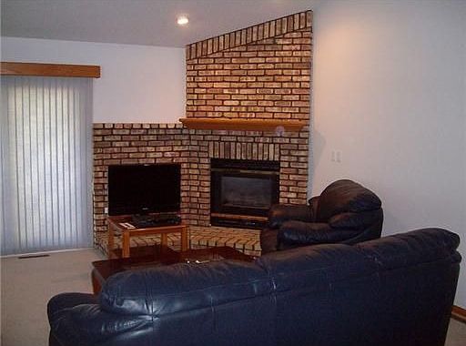 Living Room: Living room with a gas fireplace and vaulted ceiling