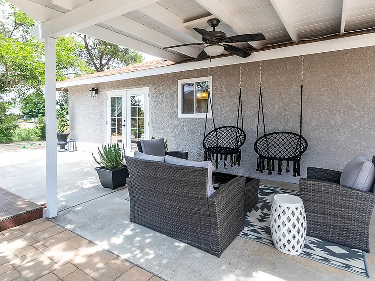 Backyard with conversation seating and covered patio