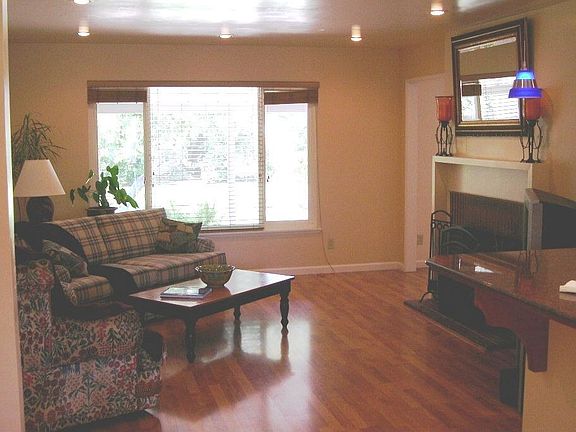 Living room has fireplace, recessed lighting, and built-in bookcase.